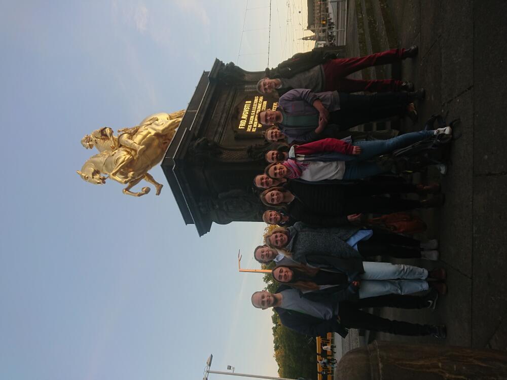 Project partners of the innovatION project pose in front of the Golden Rider in Dresden